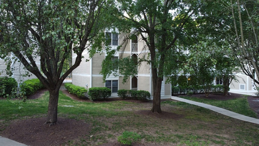 a white house with trees in front of it