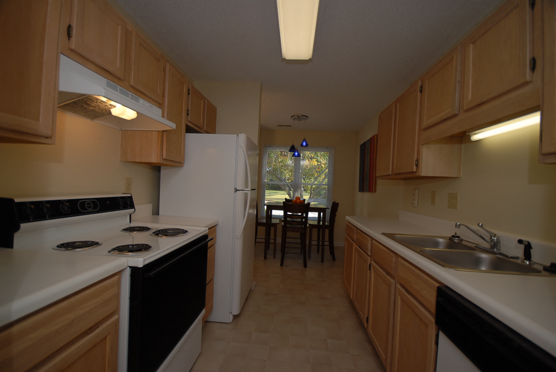 a kitchen and dining room with a table and a refrigerator