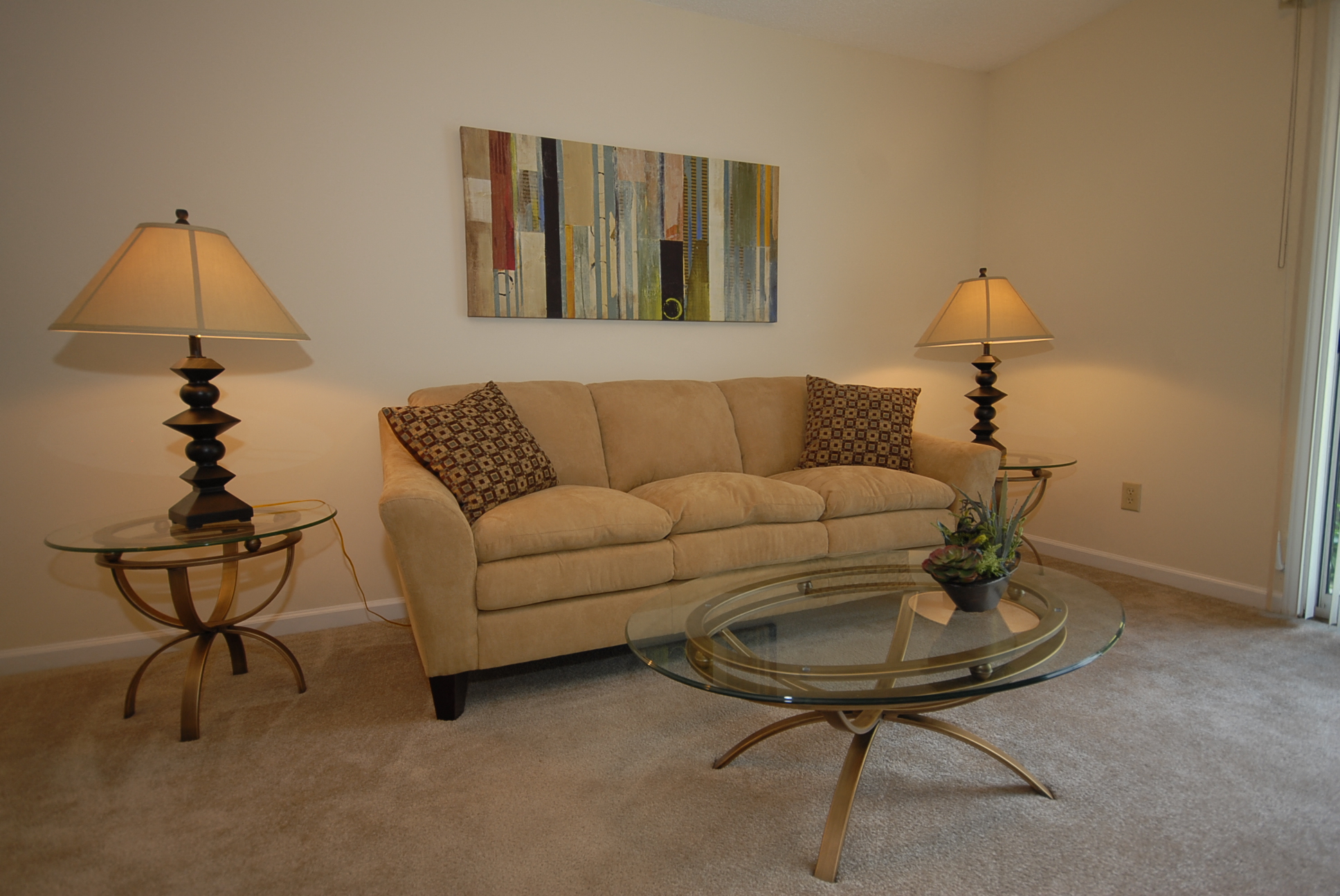 a living room with a couch and a glass table