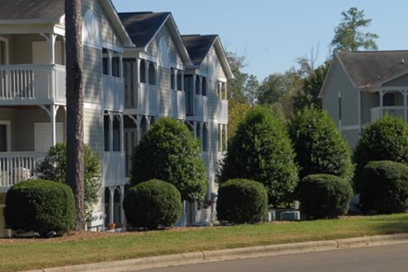 a row of houses on the side of a street