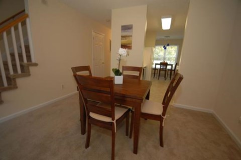 a dining room with a wooden table and chairs