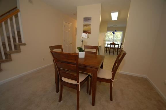 a dining room with a wooden table and chairs