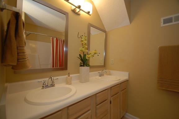 a bathroom with two sinks and a mirror
