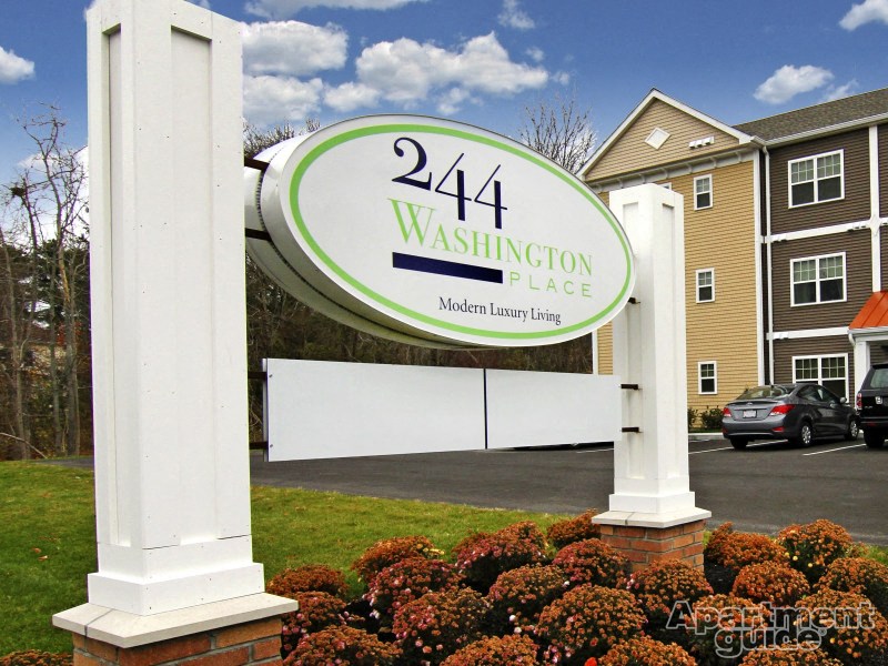 a sign place in front of a parking lot