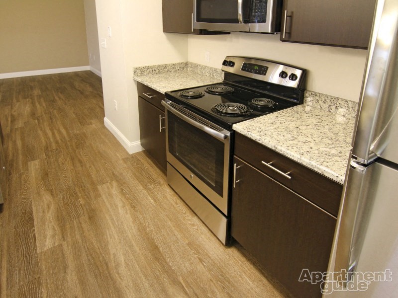 a kitchen with stainless steel appliances and granite counter tops