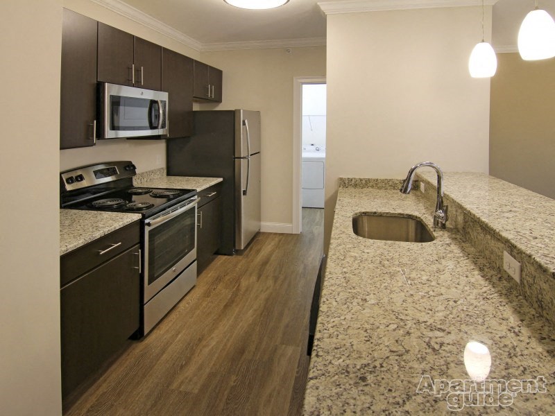 a kitchen with granite counter tops and stainless steel appliances