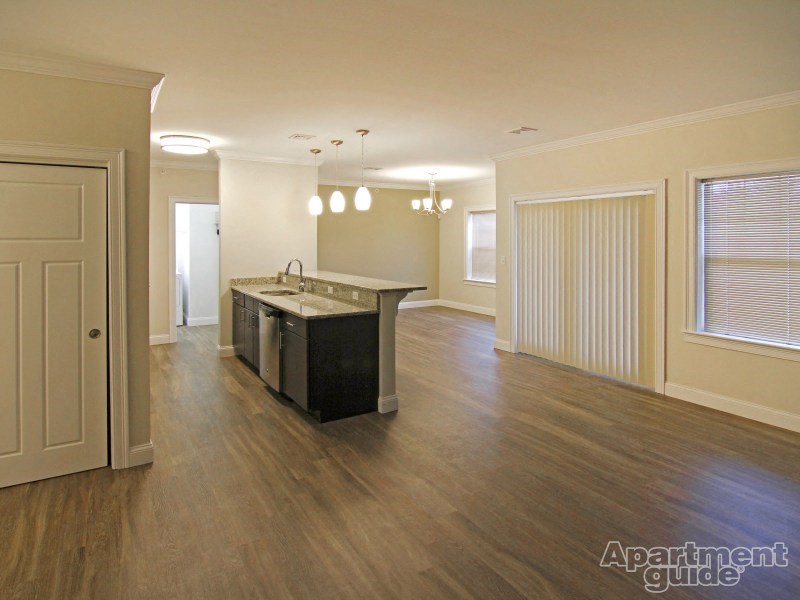 an empty kitchen and living room with an island in the middle