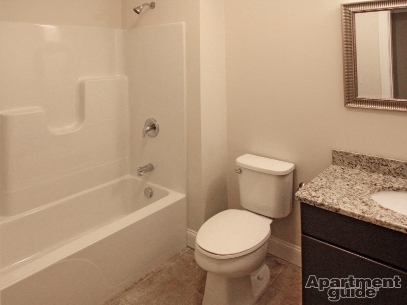a bathroom with a toilet and a tub and a sink