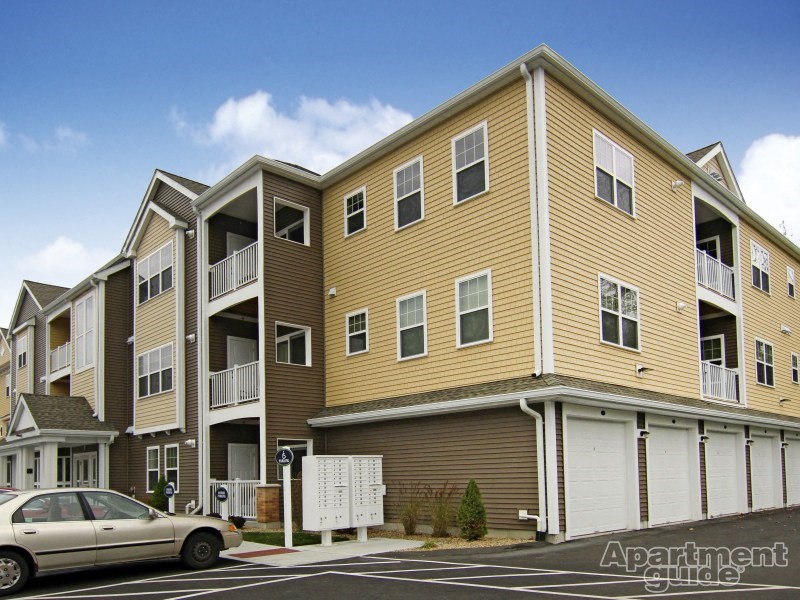 a row of houses with cars parked in front of them