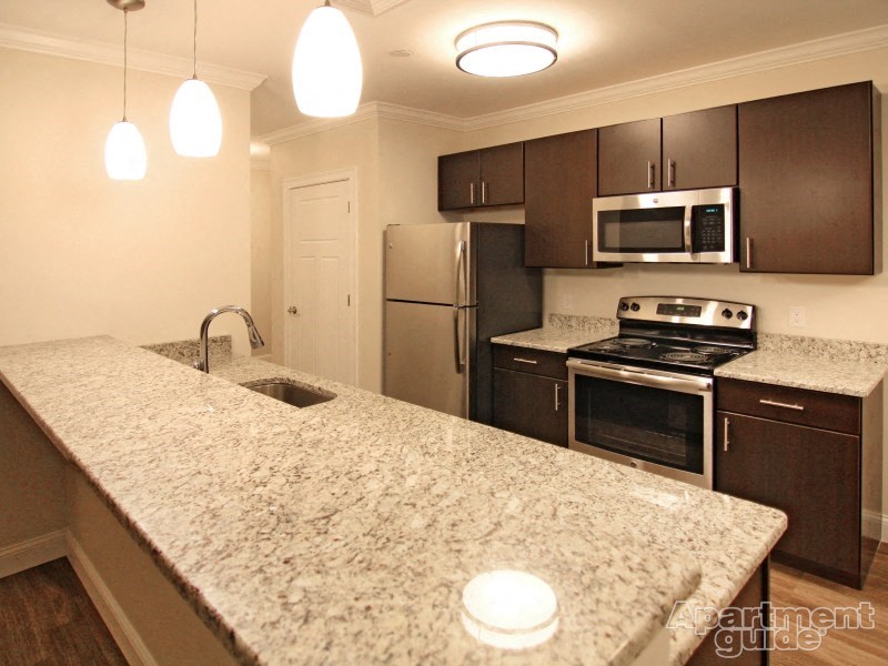 a kitchen with granite counter tops and stainless steel appliances