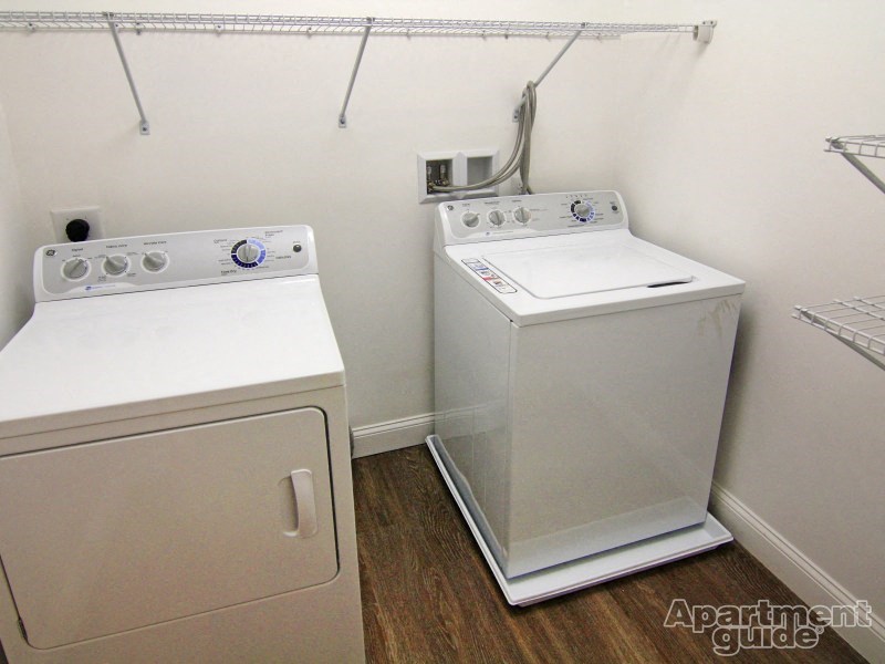 a white washer and dryer in a room with a washing machine