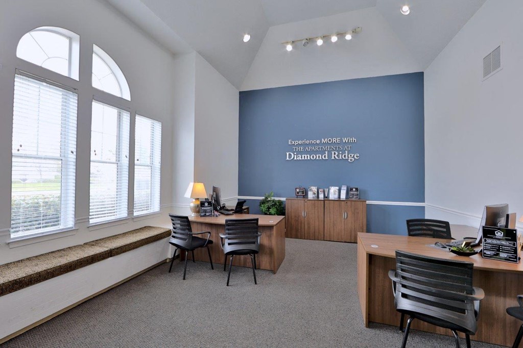 an office with a blue wall and desks and chairs