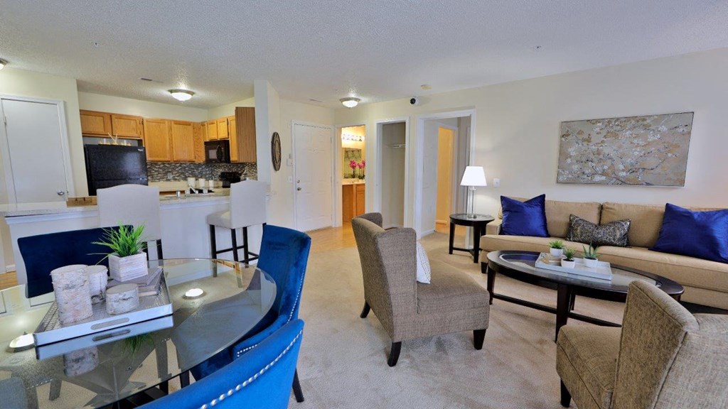 a living room and kitchen with a table and chairs