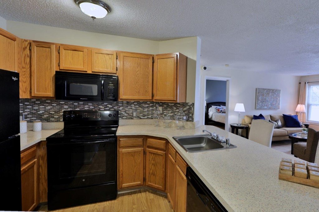 a kitchen with black appliances and a counter top