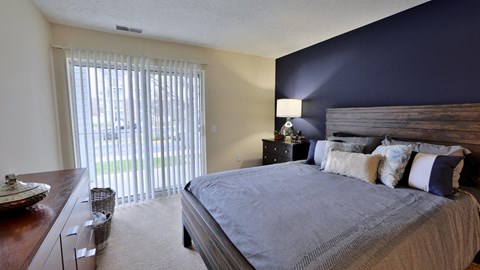 a bedroom with a large bed and a large window