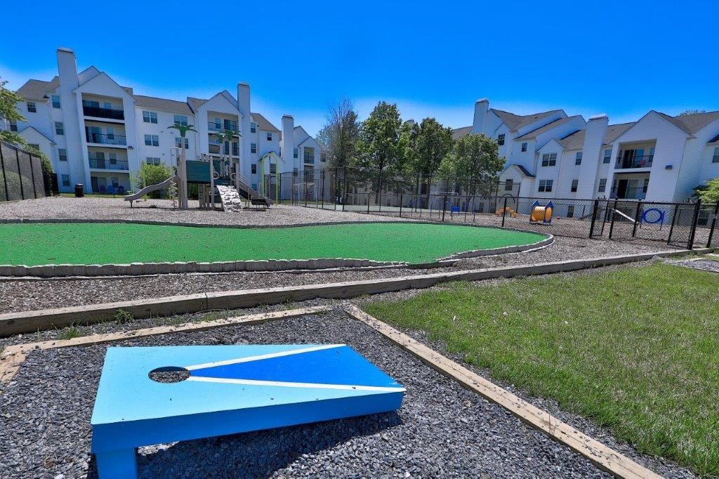 a blue ping pong table in front of an apartment complex