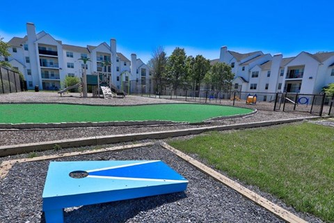a blue ping pong table in front of an apartment complex