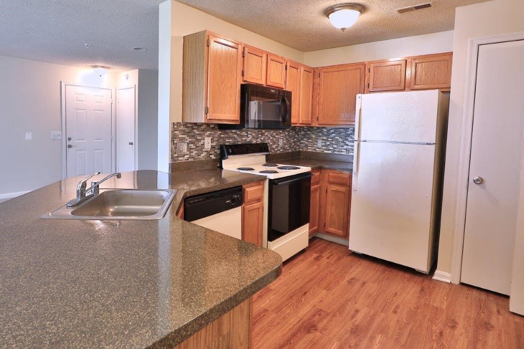 a kitchen with a sink and a refrigerator