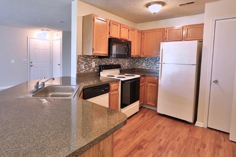 a kitchen with a sink and a refrigerator