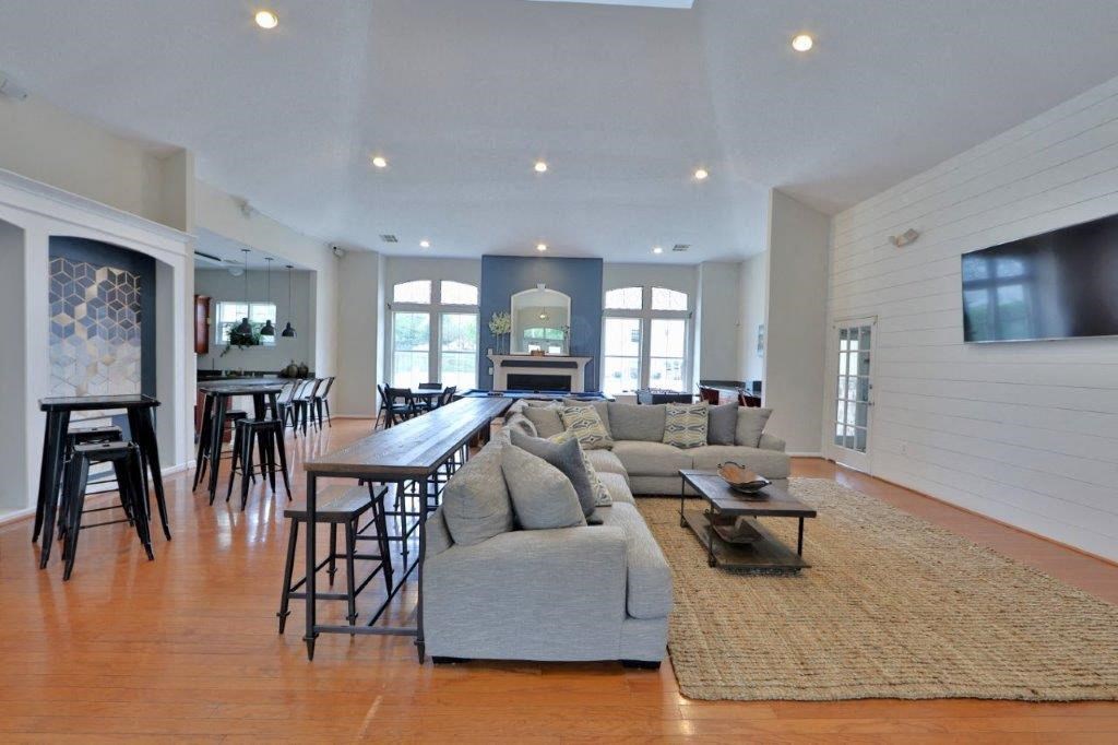 a large living room with a couch and a bar