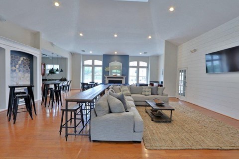 a large living room with a couch and a bar
