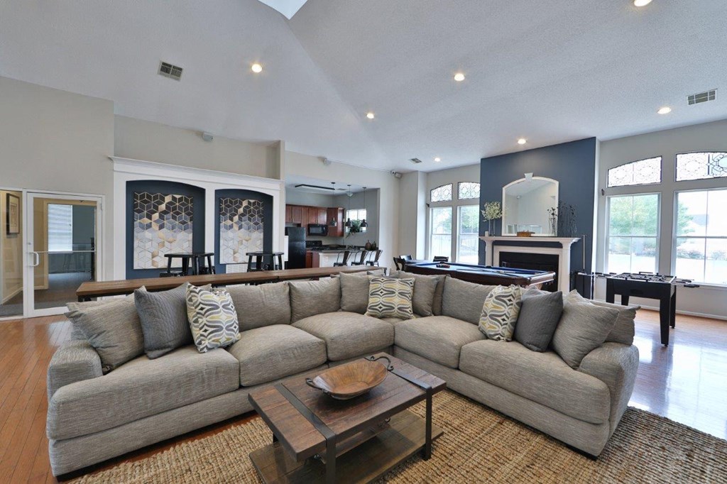 a large living room with a large couch and a table