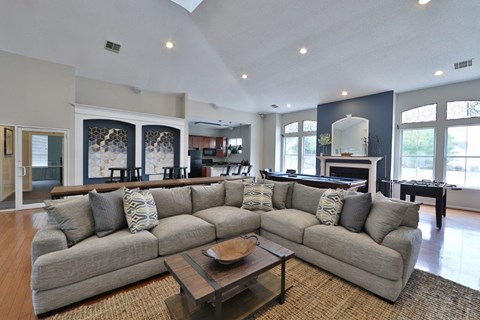 a large living room with a large couch and a table