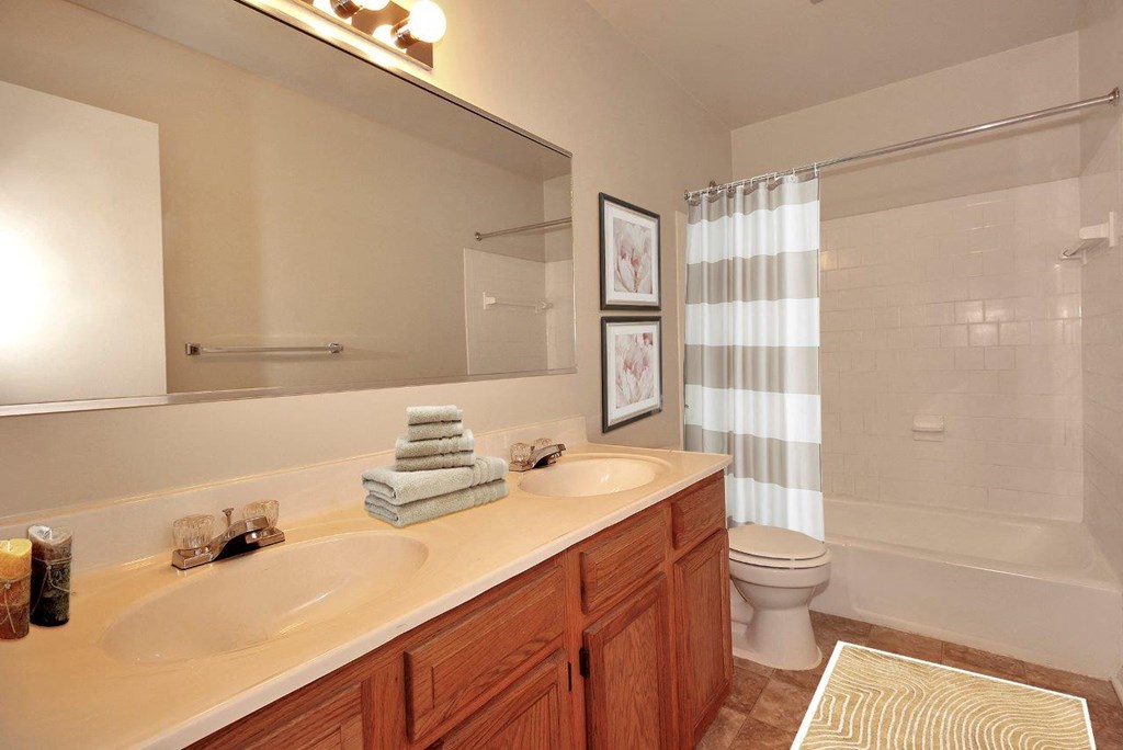a bathroom with two sinks and a toilet