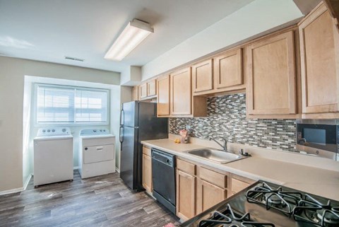 a kitchen with wooden cabinets and a stove and a sink