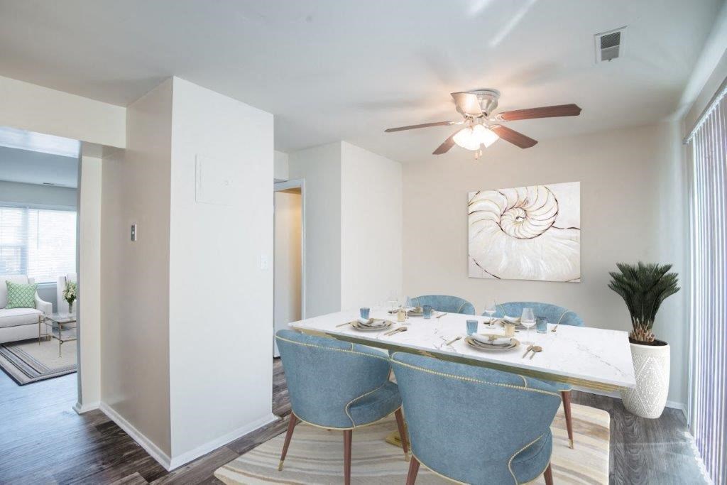 a dining room with a table and a ceiling fan