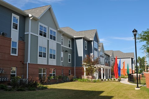 Modern apartment community featuring contemporary architecture, beautifully maintained landscaping, and inviting curb appeal.