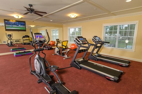 an inviting gym for residents to use weights or cardio machines.
