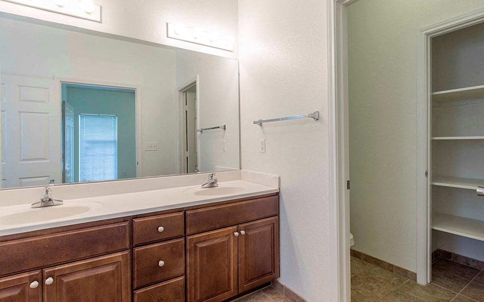 a bathroom with two sinks and a large mirror