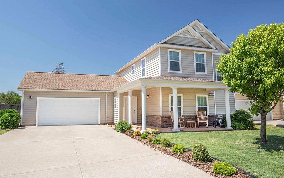 a white house with a driveway and a garage door
