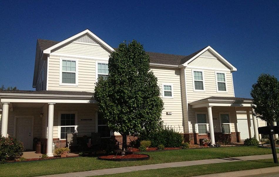 a white house with a tree in front of it