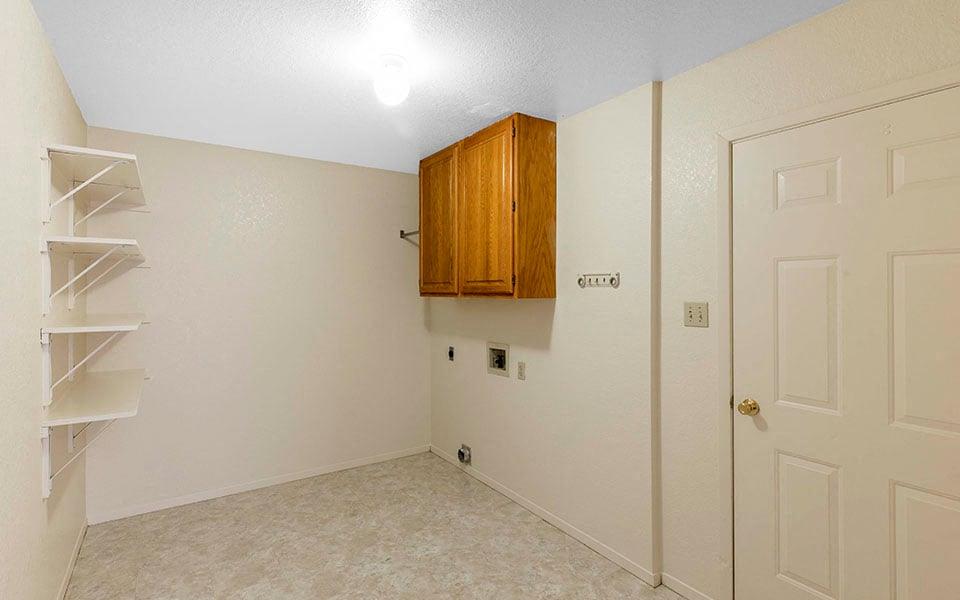 an empty room with a closet and a white door