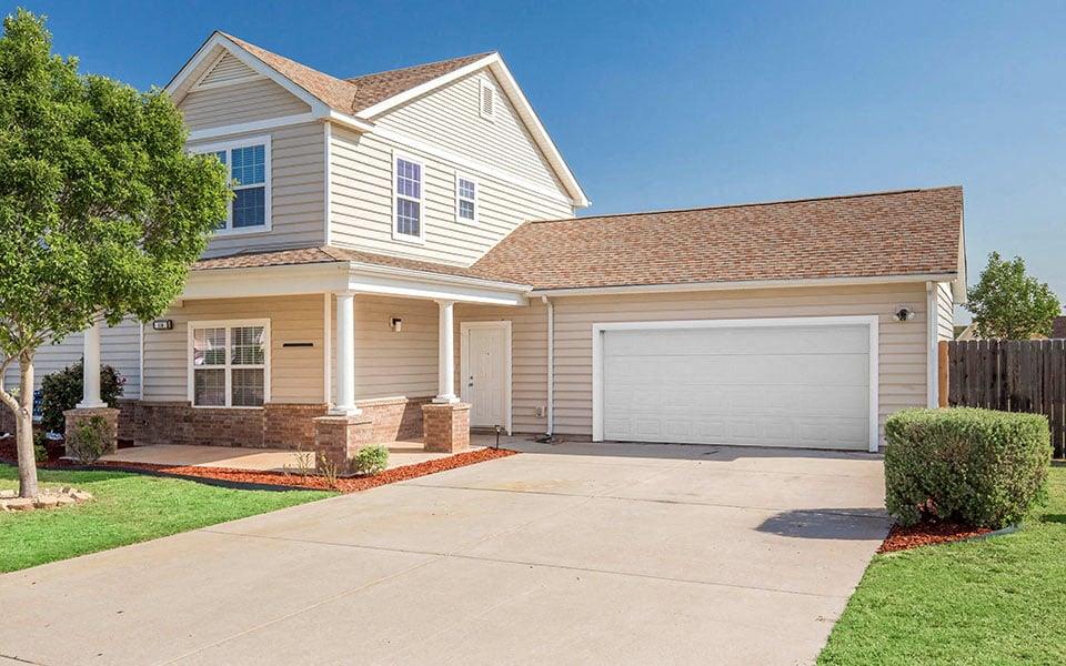a house with a driveway and a garage door