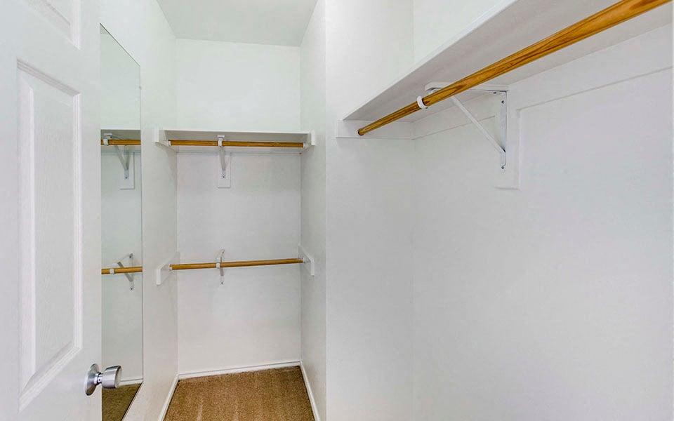 a white bathroom with a shower and a closet