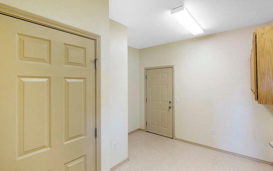 an empty room with a door and a closet