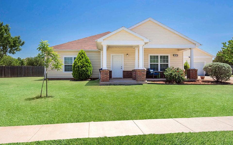 a white house with a lawn in front of it