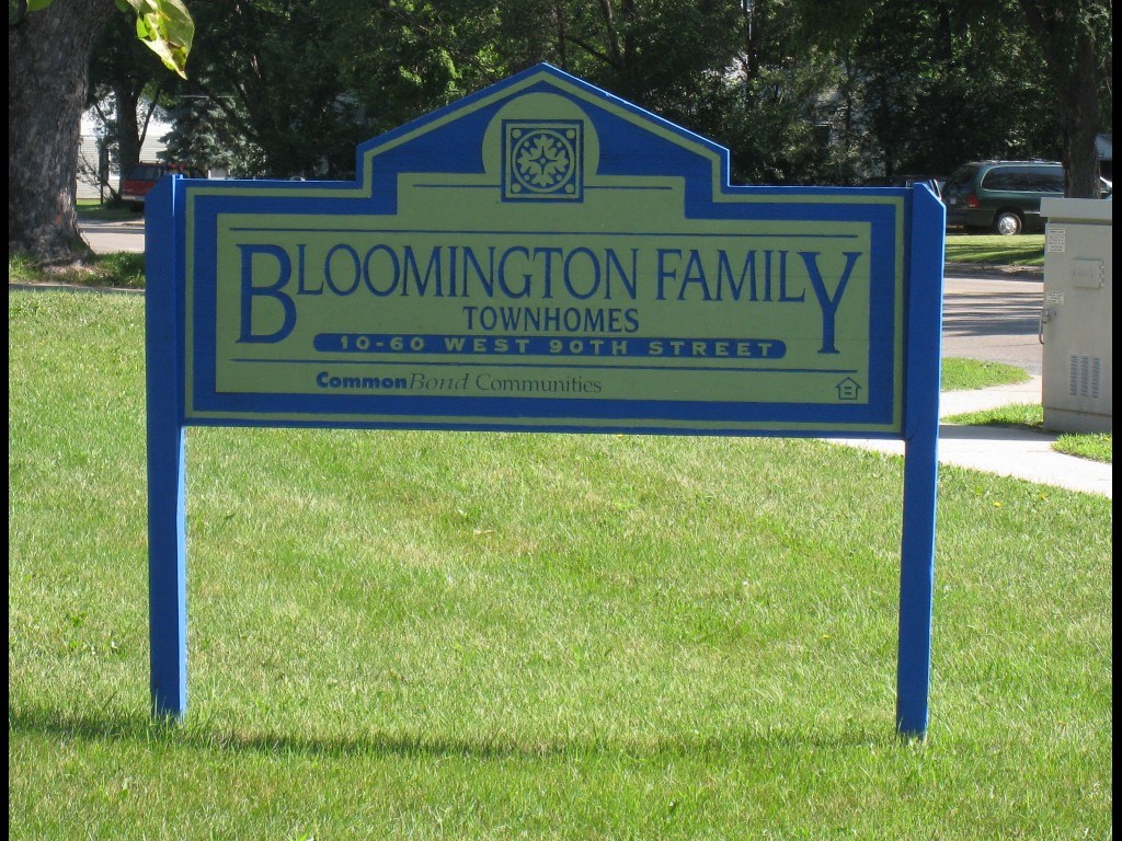 a sign family townhomes in front of a park