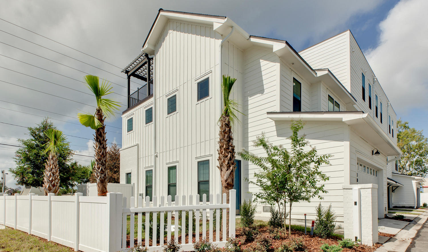 a white house with a fence in front of it