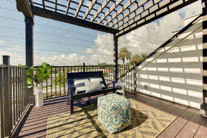 a porch with a bench and a chair on it