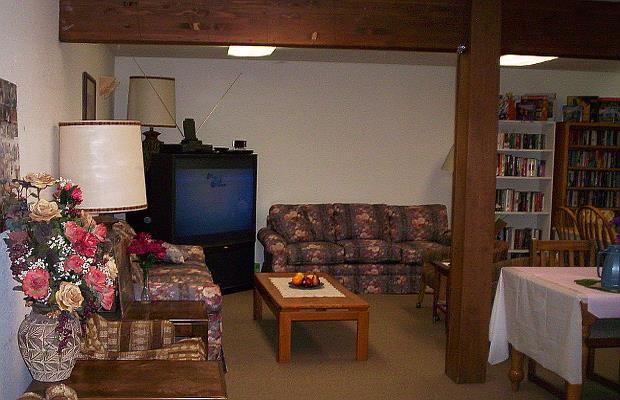 a living room with two couches a table and a tv