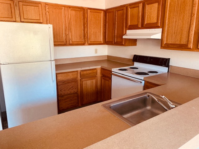 a kitchen with a sink and a refrigerator