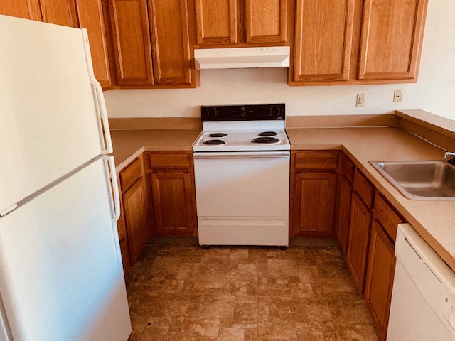 a small kitchen with a stove and a refrigerator