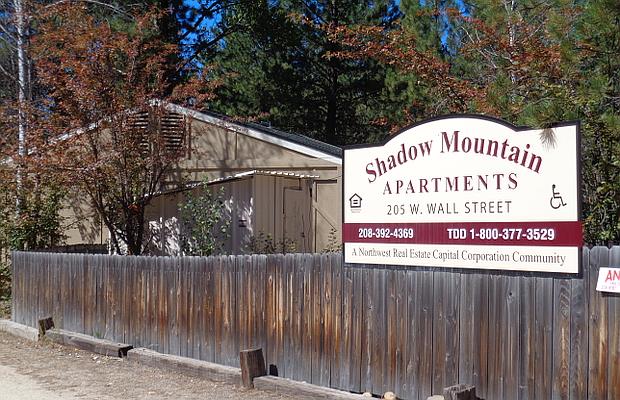 a sign on a fence in front of a building