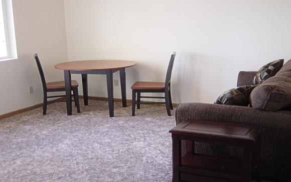 a living room with a table and a couch