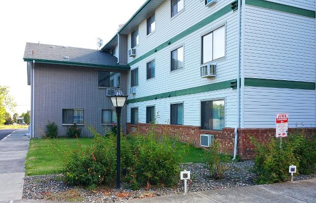 a white and green house with a street light