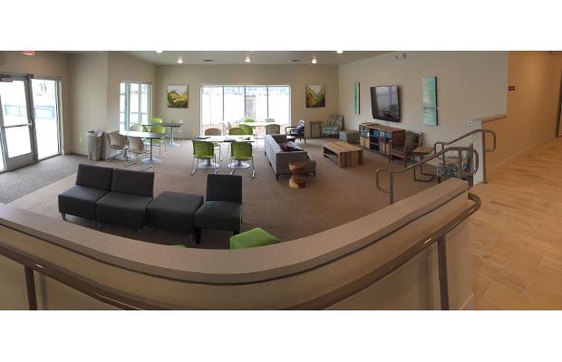 a living room with a bar and furniture in it